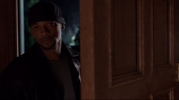 Movie still from “I, Robot” (2004), directed by Alex Proyas – A man standing in front of a door at night; Close Up shot, Over the shoulder angle