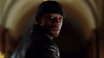 Movie still from “I, Robot” (2004), directed by Alex Proyas – A person wearing a leather jacket; Close Up shot, Low angle