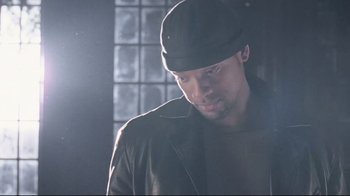 Movie still from “I, Robot” (2004), directed by Alex Proyas – A person wearing a hat and a jacket; Close Up shot, Low angle
