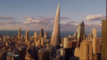 Movie still from “I, Robot” (2004), directed by Alex Proyas – An aerial view of a skyscraper in the middle of a city; Extreme Wide shot, High angle