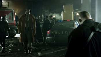 Movie still from “I, Robot” (2004), directed by Alex Proyas – A group of men standing next to a police car at night; Wide shot, Low angle