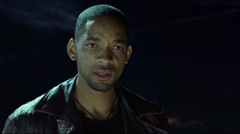 Movie still from “I, Robot” (2004), directed by Alex Proyas – A man in a leather jacket looking at the camera; Close Up shot, Over the shoulder angle