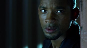 Movie still from “I, Robot” (2004), directed by Alex Proyas – A man's face in the dark; Close Up shot, Over the shoulder angle