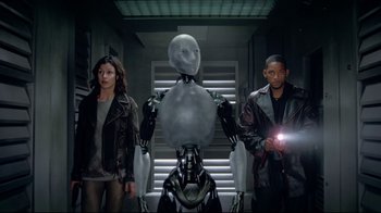Movie still from “I, Robot” (2004), directed by Alex Proyas – A group of people standing next to each other in a room; Medium shot, Low angle