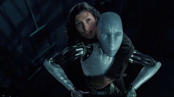 Movie still from “I, Robot” (2004), directed by Alex Proyas – A woman holding a robot in her arms; Close Up shot, Overhead angle