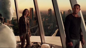Movie still from “I, Robot” (2004), directed by Alex Proyas – A woman standing on top of a tall building; Wide shot, Low angle