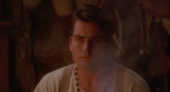 Movie still from “Hot Shots!” (1991), directed by Jim Abrahams – A man with a beard is smoking a cigarette; Close Up shot, High angle