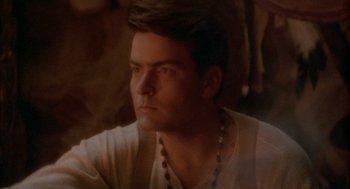 Movie still from “Hot Shots!” (1991), directed by Jim Abrahams – A person wearing a necklace; Close Up shot, Over the shoulder angle
