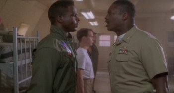 Movie still from “Hot Shots!” (1991), directed by Jim Abrahams – Two men in military uniforms talking to each other; Medium shot, Low angle