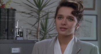 Movie still from “Hot Shots!” (1991), directed by Jim Abrahams – A person wearing a suit; Close Up shot, Over the shoulder angle
