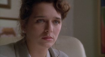 Movie still from “Hot Shots!” (1991), directed by Jim Abrahams – A person wearing a white shirt; Close Up shot, Over the shoulder angle