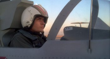 Movie still from “Hot Shots!” (1991), directed by Jim Abrahams – A man wearing a helmet sitting in the cockpit of an airplane; Close Up shot, Low angle