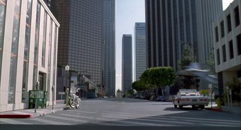 Movie still from “Hot Shots!” (1991), directed by Jim Abrahams – A bike parked on the side of a road near a tree; Extreme Wide shot, High angle