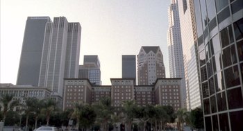 Movie still from “Hot Shots!” (1991), directed by Jim Abrahams – A view of a large building with many windows; Extreme Wide shot, High angle
