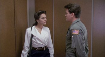 Movie still from “Hot Shots!” (1991), directed by Jim Abrahams – A man and a woman standing next to each other in front of each other; Medium shot, Over the shoulder angle