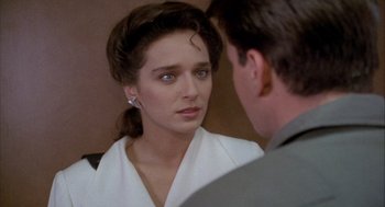 Movie still from “Hot Shots!” (1991), directed by Jim Abrahams – A woman looking at a man in the mirror; Close Up shot, Over the shoulder angle