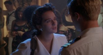 Movie still from “Hot Shots!” (1991), directed by Jim Abrahams – A woman in a white dress is talking to a man; Close Up shot, Over the shoulder angle