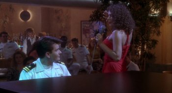 Movie still from “Hot Shots!” (1991), directed by Jim Abrahams – A man and a woman are sitting at a table; Medium shot, Over the shoulder angle