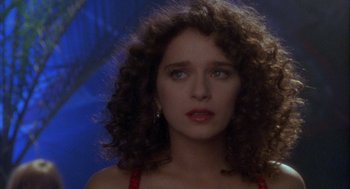 Movie still from “Hot Shots!” (1991), directed by Jim Abrahams – A person with curly brown hair; Close Up shot, Over the shoulder angle