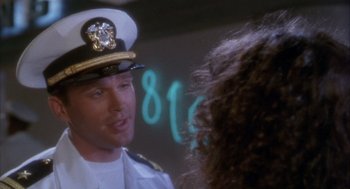 Movie still from “Hot Shots!” (1991), directed by Jim Abrahams – A man in a naval uniform talking to a woman; Close Up shot, Over the shoulder angle