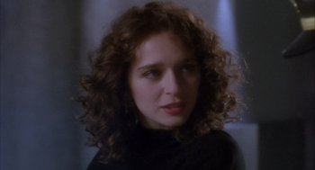 Movie still from “Hot Shots!” (1991), directed by Jim Abrahams – A person with curly hair; Close Up shot, Over the shoulder angle