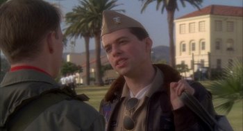 Movie still from “Hot Shots!” (1991), directed by Jim Abrahams – A young man in a military uniform talking to another man; Close Up shot, Over the shoulder angle