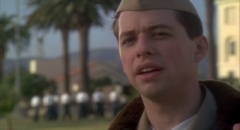 Movie still from “Hot Shots!” (1991), directed by Jim Abrahams – A man wearing a hat in front of a group of people; Close Up shot, Low angle