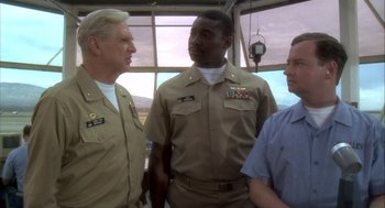 Movie still from “Hot Shots!” (1991), directed by Jim Abrahams – A group of men standing next to each other; Medium shot, Low angle