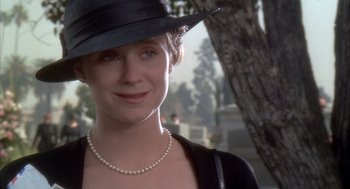 Movie still from “Hot Shots!” (1991), directed by Jim Abrahams – A person wearing a hat and a necklace; Close Up shot, Over the shoulder angle