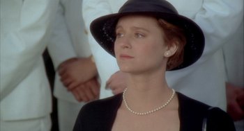Movie still from “Hot Shots!” (1991), directed by Jim Abrahams – A woman wearing a black hat and a white jacket; Close Up shot, Low angle