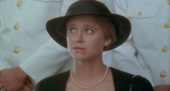 Movie still from “Hot Shots!” (1991), directed by Jim Abrahams – A person wearing a hat and a necklace; Close Up shot, Low angle