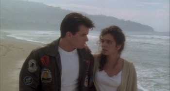 Movie still from “Hot Shots!” (1991), directed by Jim Abrahams – A man and a woman standing next to each other near the ocean; Medium shot, Over the shoulder angle