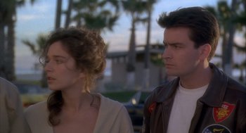 Movie still from “Hot Shots!” (1991), directed by Jim Abrahams – A man and a woman standing next to each other; Close Up shot, Over the shoulder angle