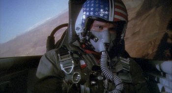 Movie still from “Hot Shots!” (1991), directed by Jim Abrahams – A man in a fighter pilot's helmet with american flag on it; Close Up shot, Low angle