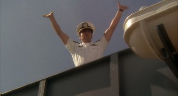 Movie still from “Hot Shots!” (1991), directed by Jim Abrahams – A man in a white uniform and a white hat; Medium shot, Low angle