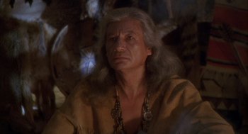 Movie still from “Hot Shots!” (1991), directed by Jim Abrahams – An older man with long hair and a beard; Close Up shot, High angle