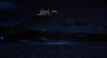 Movie still from “Hot Shots! Part Deux” (1993), directed by Jim Abrahams – A castle on top of a hill lit up at night; Extreme Wide shot, High angle