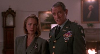 Movie still from “Hot Shots! Part Deux” (1993), directed by Jim Abrahams – A man and a woman standing next to each other in a room; Close Up shot, Low angle