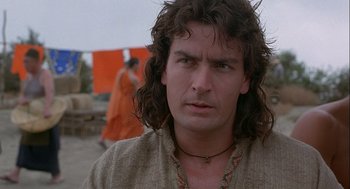 Movie still from “Hot Shots! Part Deux” (1993), directed by Jim Abrahams – A person with long curly hair; Close Up shot, Low angle