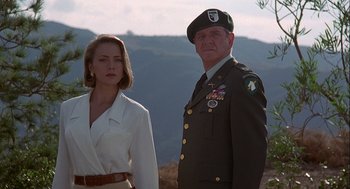 Movie still from “Hot Shots! Part Deux” (1993), directed by Jim Abrahams – A man and a woman standing next to each other in front of mountains; Medium shot, Low angle