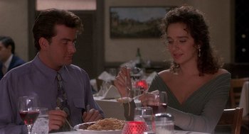 Movie still from “Hot Shots! Part Deux” (1993), directed by Jim Abrahams – A man and a woman sitting at a table eating spaghetti; Medium shot, Over the shoulder angle