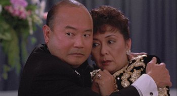Movie still from “Hot Shots! Part Deux” (1993), directed by Jim Abrahams – A man and a woman pose for a picture; Close Up shot, High angle