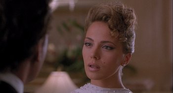 Movie still from “Hot Shots! Part Deux” (1993), directed by Jim Abrahams – A person wearing a white dress; Close Up shot, Over the shoulder angle