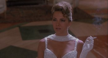 Movie still from “Hot Shots! Part Deux” (1993), directed by Jim Abrahams – A woman in a white dress is looking at the camera; Close Up shot, Over the shoulder angle