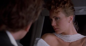 Movie still from “Hot Shots! Part Deux” (1993), directed by Jim Abrahams – A woman looking into a mirror while a man looks on; Close Up shot, Over the shoulder angle