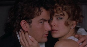 Movie still from “Hot Shots! Part Deux” (1993), directed by Jim Abrahams – A man and a woman face to face with their eyes closed; Close Up shot, Low angle