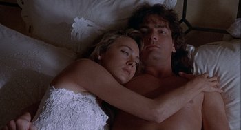 Movie still from “Hot Shots! Part Deux” (1993), directed by Jim Abrahams – A man and a woman laying in bed together; Close Up shot, Overhead angle