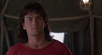 Movie still from “Hot Shots! Part Deux” (1993), directed by Jim Abrahams – A person wearing a red shirt; Close Up shot, Low angle