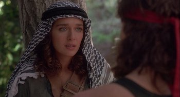 Movie still from “Hot Shots! Part Deux” (1993), directed by Jim Abrahams – A woman wearing a keffiyeh looking at the camera; Close Up shot, Over the shoulder angle