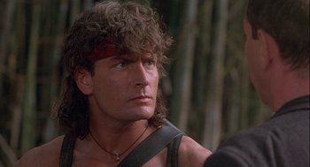 Movie still from “Hot Shots! Part Deux” (1993), directed by Jim Abrahams – A person wearing a headband; Close Up shot, Over the shoulder angle